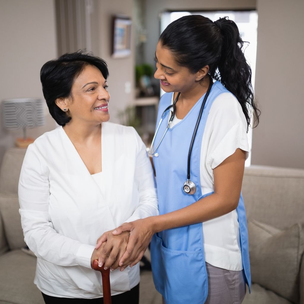 Nurse assisting elder at home | Patient getting care on bed