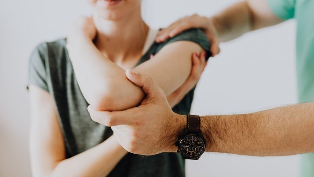 Physiotherapist treating patient at home